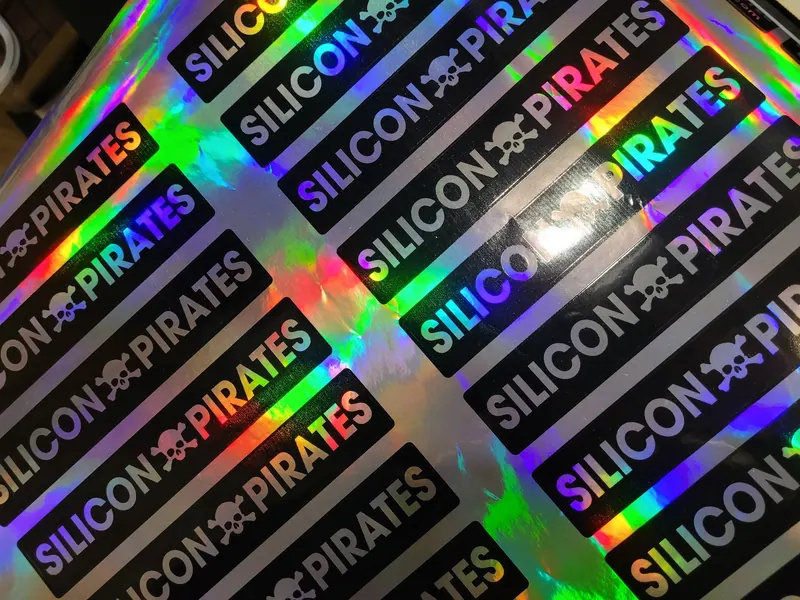 Close up of holographic Silicon Pirates name strip stickers with a small skull between the words